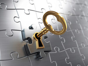 key fitting into lock on a puzzle piece