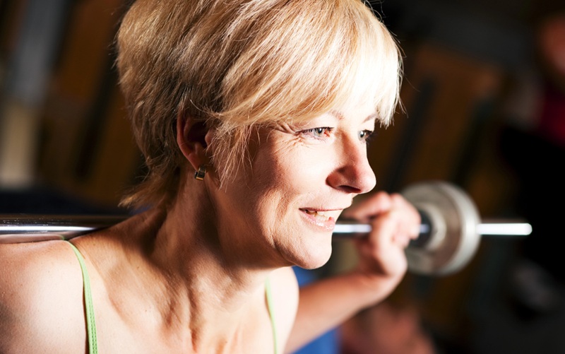 middle aged woman lifting weights