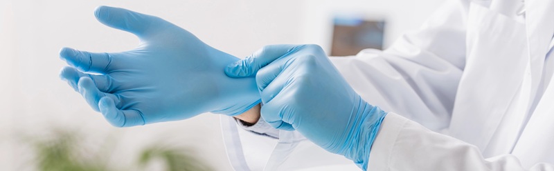 Image of surgeon putting on surgical gloves