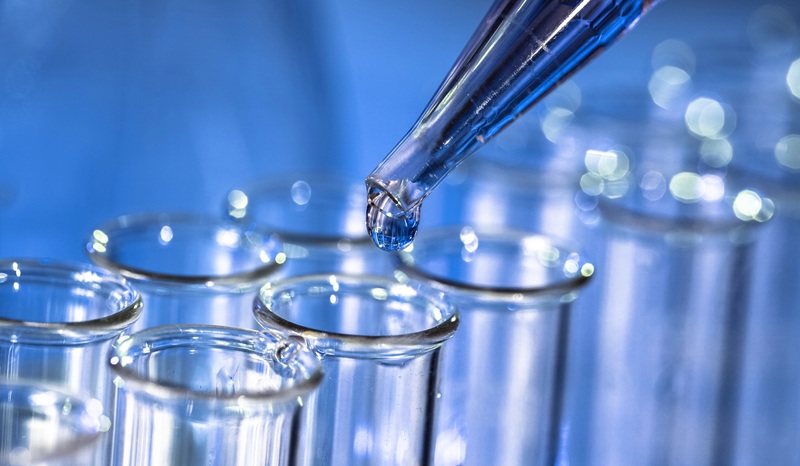 image of pipette dispensing liquid into test tubes